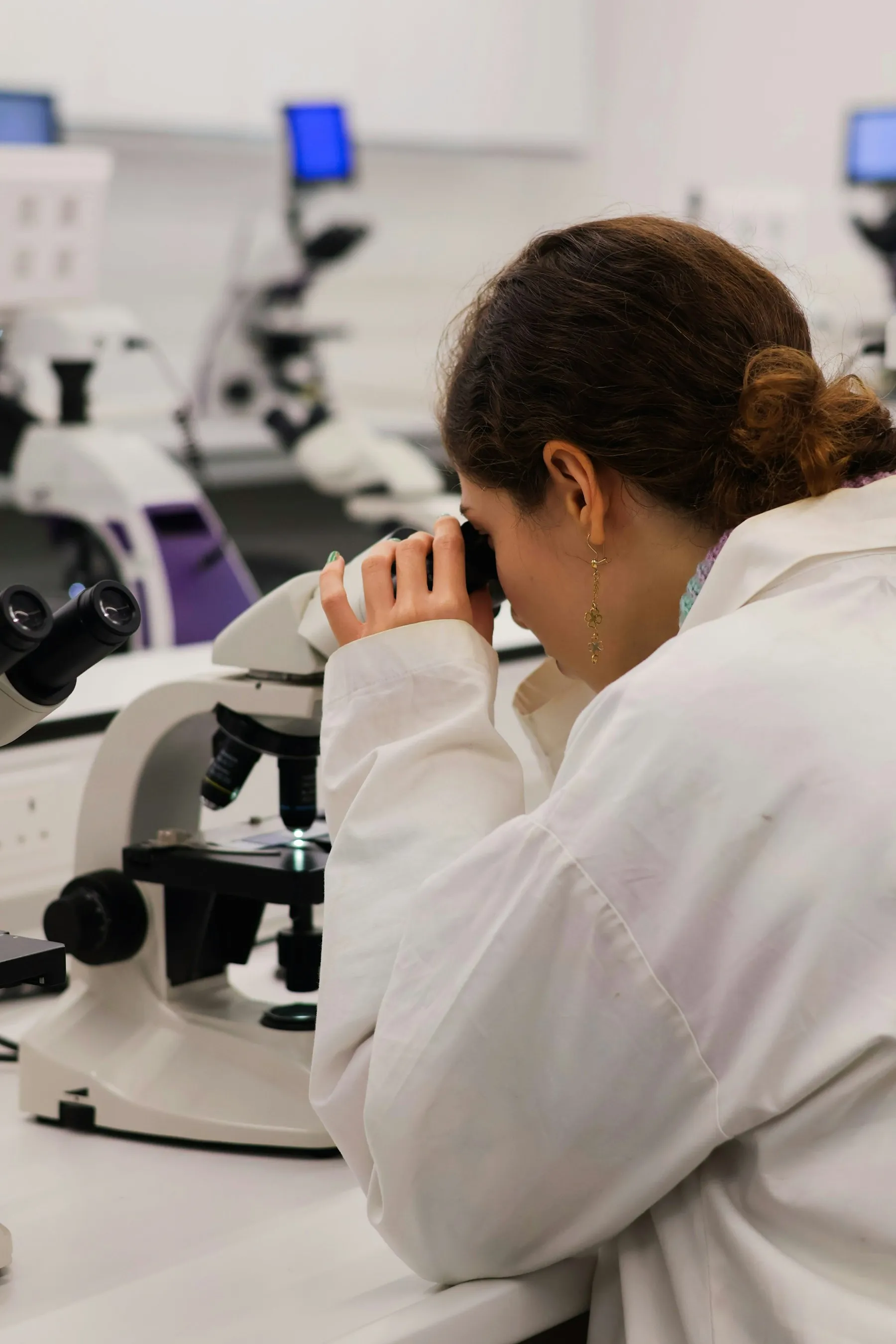 Scientist looking through a microscope in a laboratory