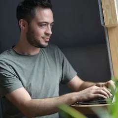 Startup founder working on a laptop in a quiet office booth
