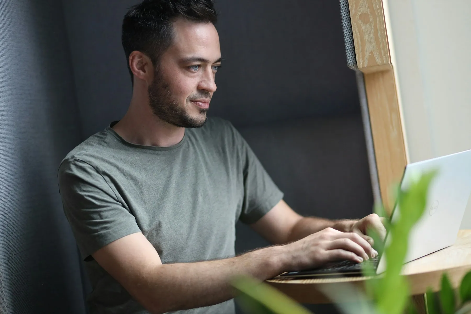 Startup founder working on a laptop in a quiet office booth