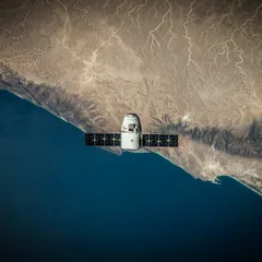 Satellite over a coastline photographed from orbit
