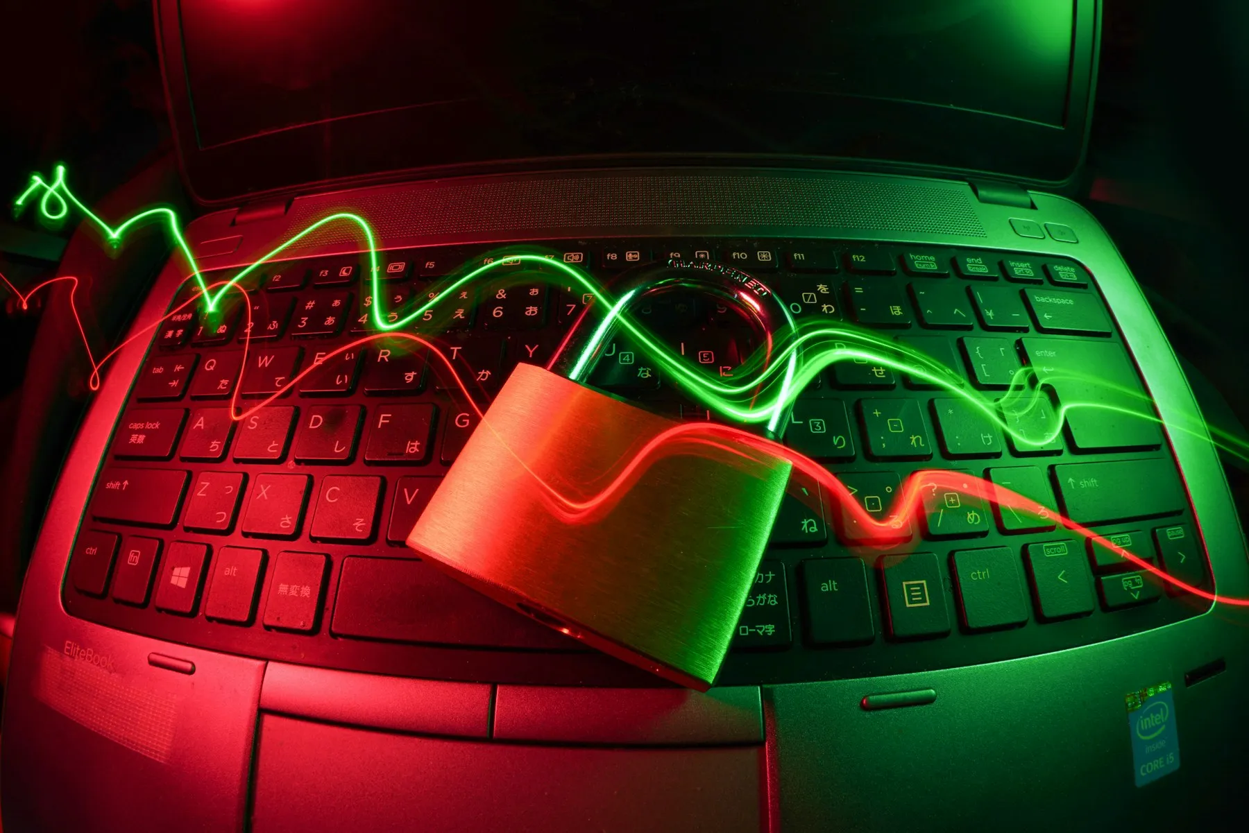 Laptop keyboard with a padlock and red green security lights
