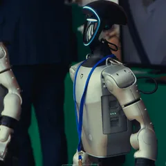 Humanoid robot with a blue lanyard and badge