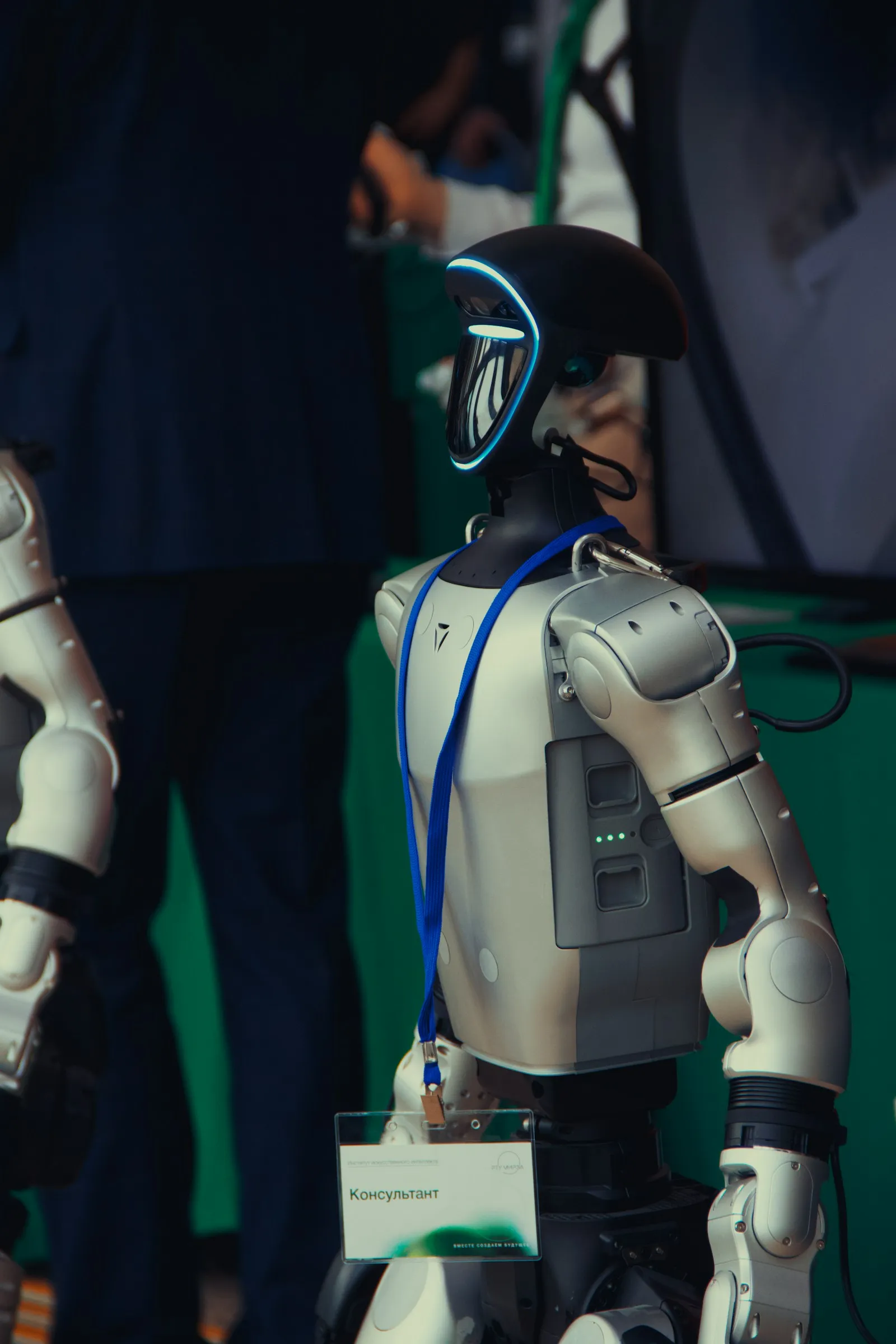 Humanoid robot with a blue lanyard and badge