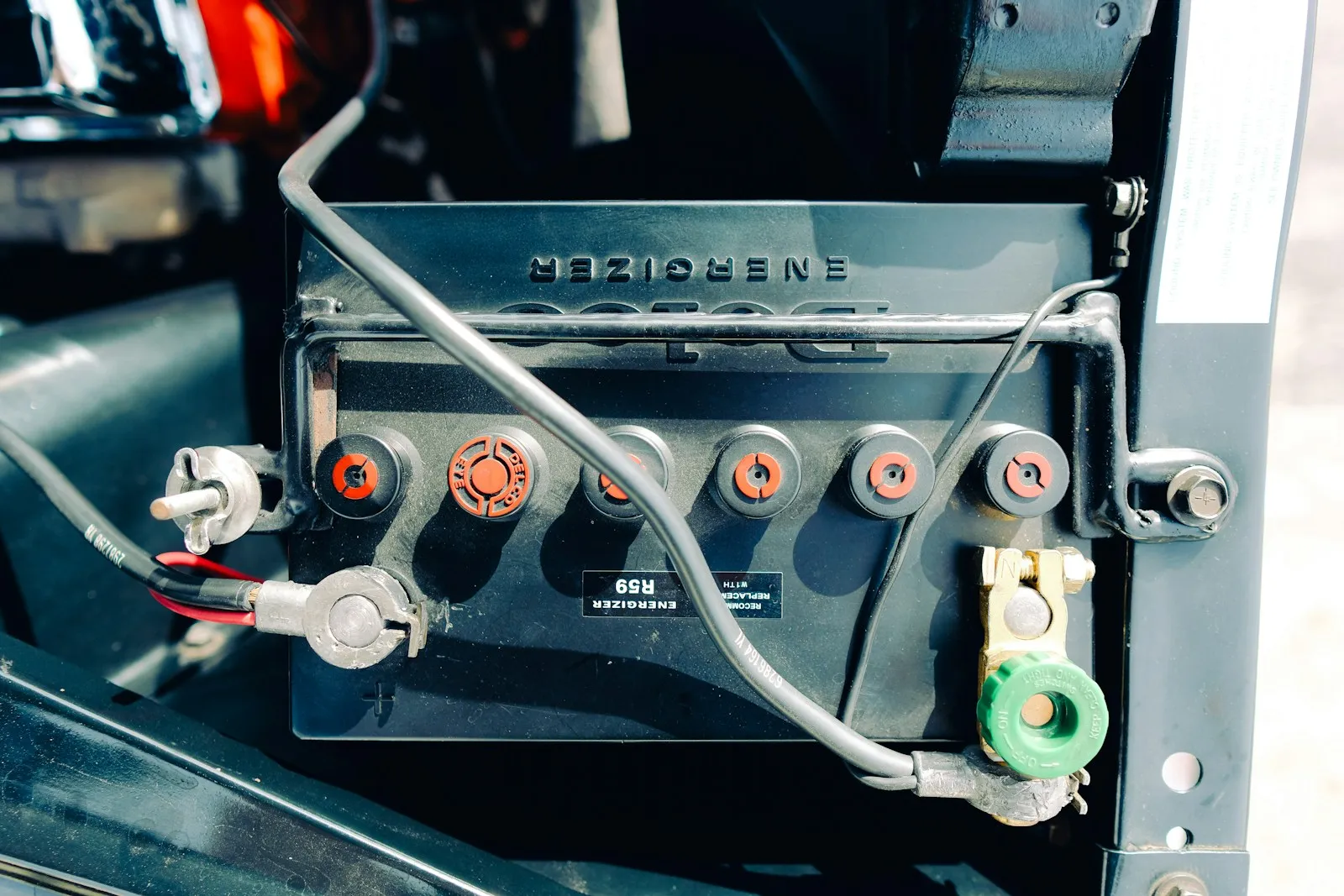 Close-up of battery wiring and terminals inside a vehicle