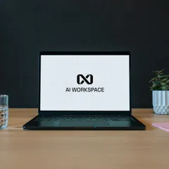 Laptop on a desk showing an AI workspace screen